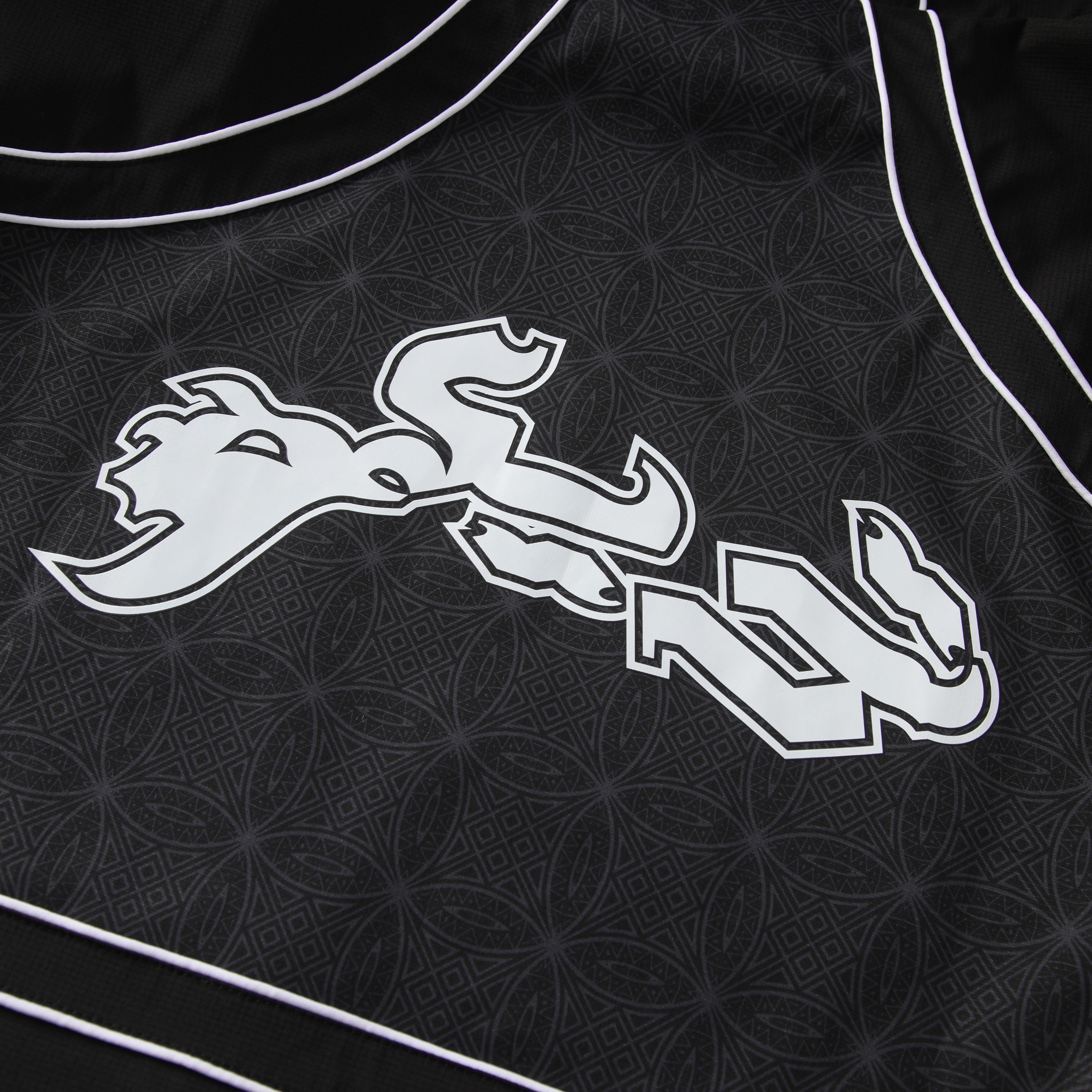 Black jacket with white logo on a dark background